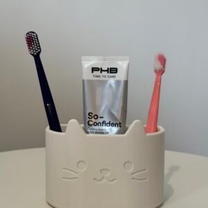 porta escovas e pasta de dente em formato de gatinho